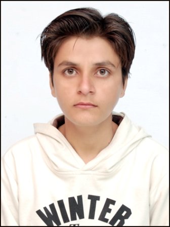 Portrait of Dr. Kapoor wearing traditional attire with academic books in background